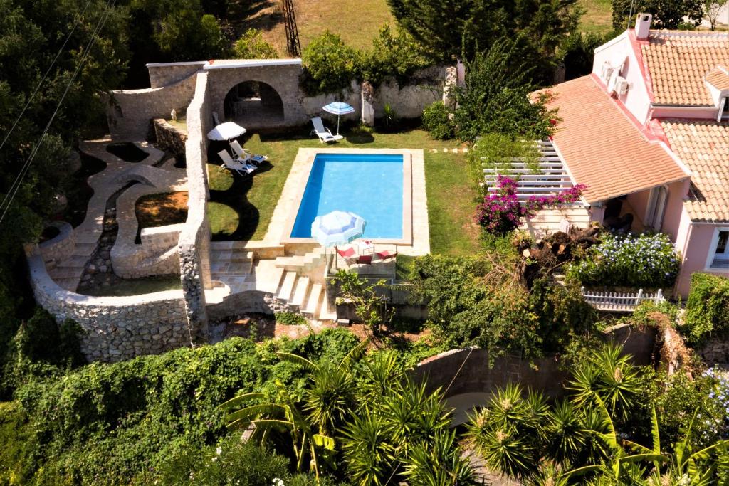 an aerial view of a house with a swimming pool at Old Olive Press Sea and Mountain in Ágios Márkos