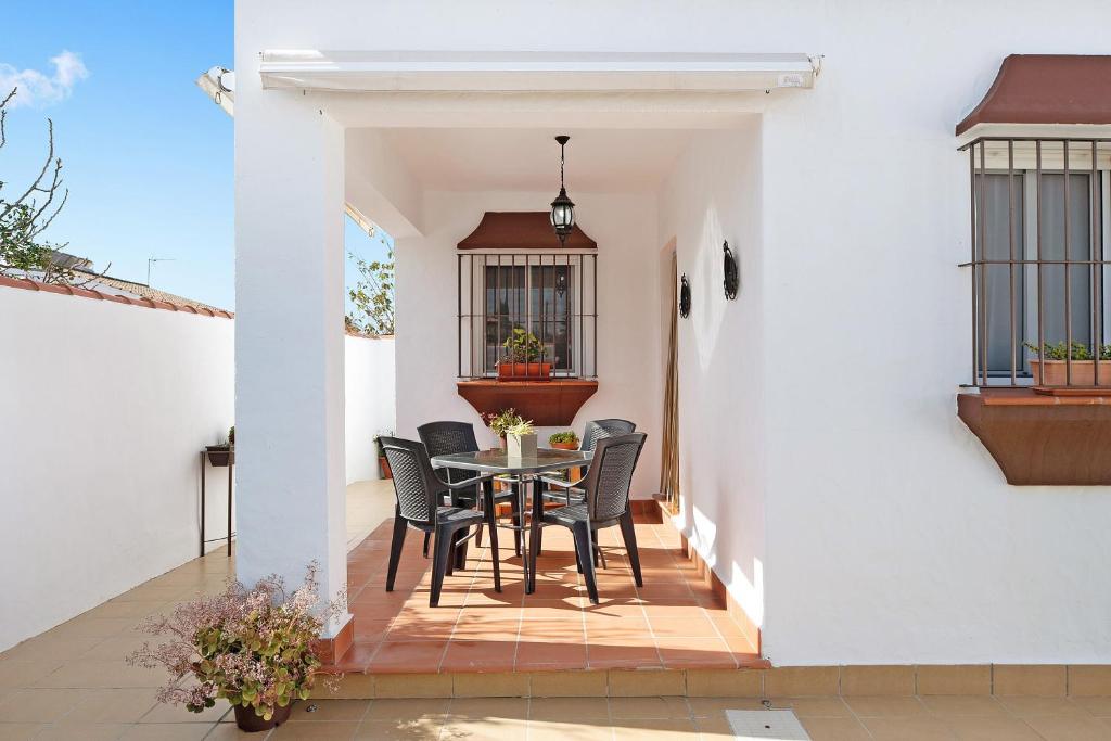 a dining room with a table and chairs on a patio at Casa Antonia 2 in Conil de la Frontera