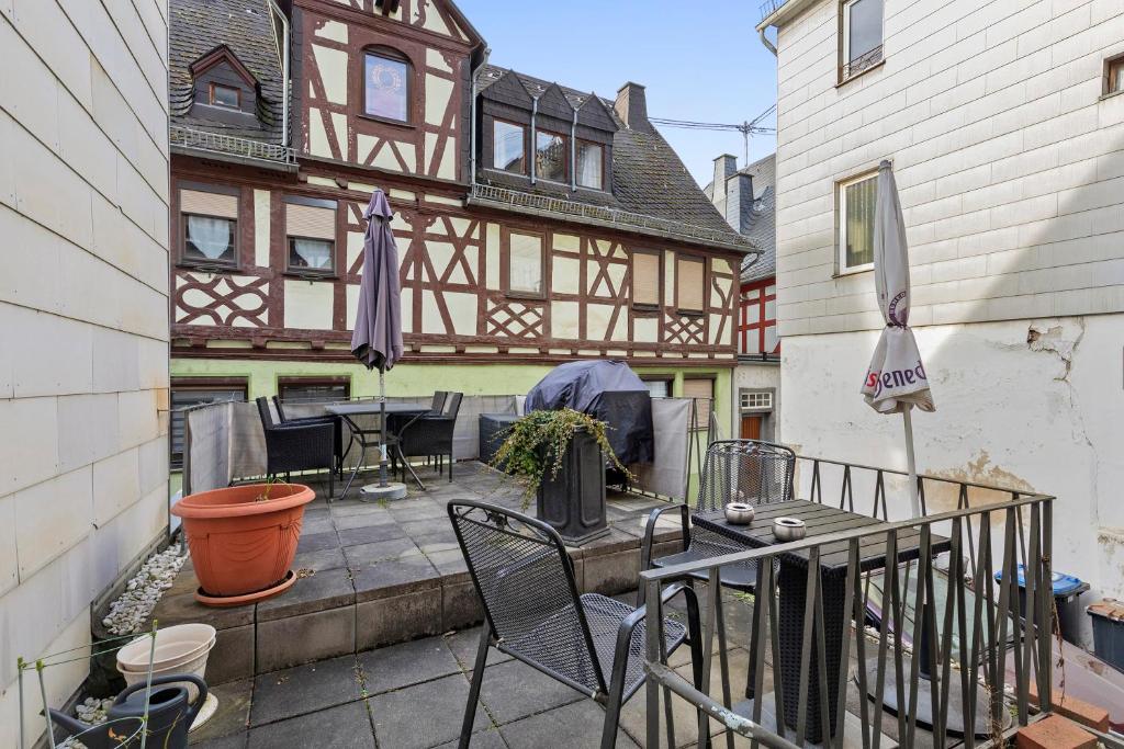 a patio with a table and chairs in front of a building at Traumschlüsselchen in Braubach