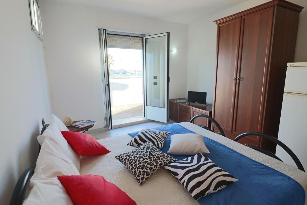 a bedroom with a bed with pillows on it at Casa vacanze Frida in Salento in Otranto