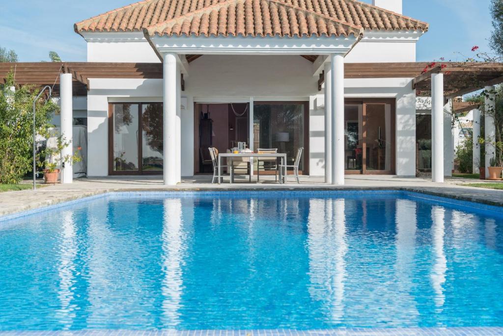 a swimming pool in front of a villa at Villa Lavanda in Benalup Casas Viejas