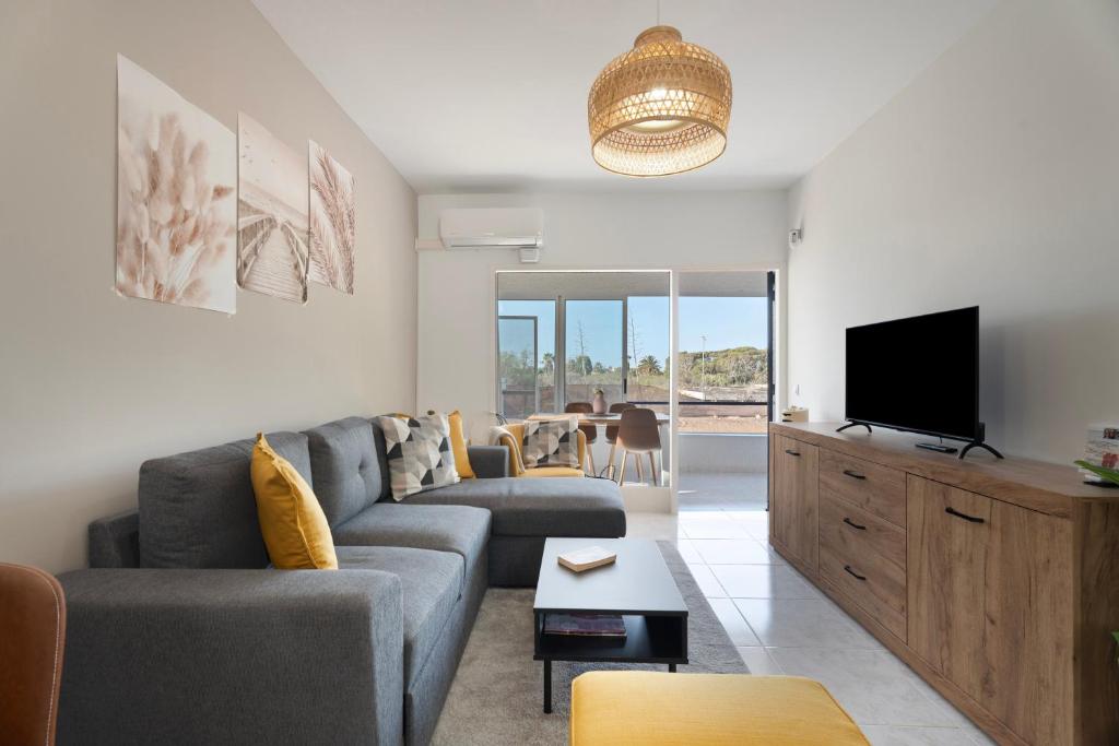 a living room with a couch and a tv at Casa Noa in Costa Del Silencio