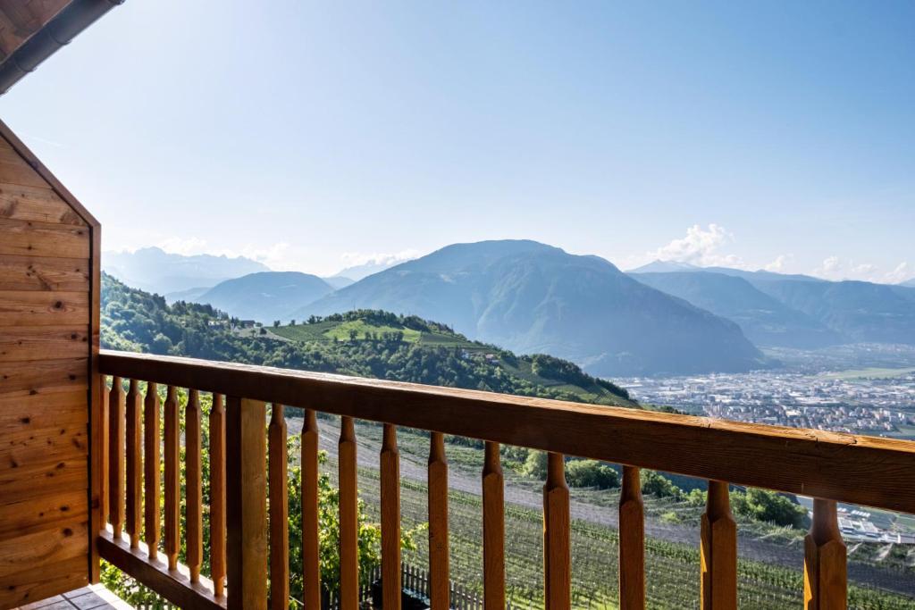 a view of mountains from a balcony of a cabin at Weingartnerhof Calendula in San Genesio Atesino