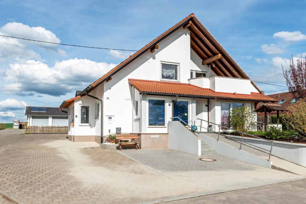 a white house with a brown roof at Arnold Laubbach in Ostrach