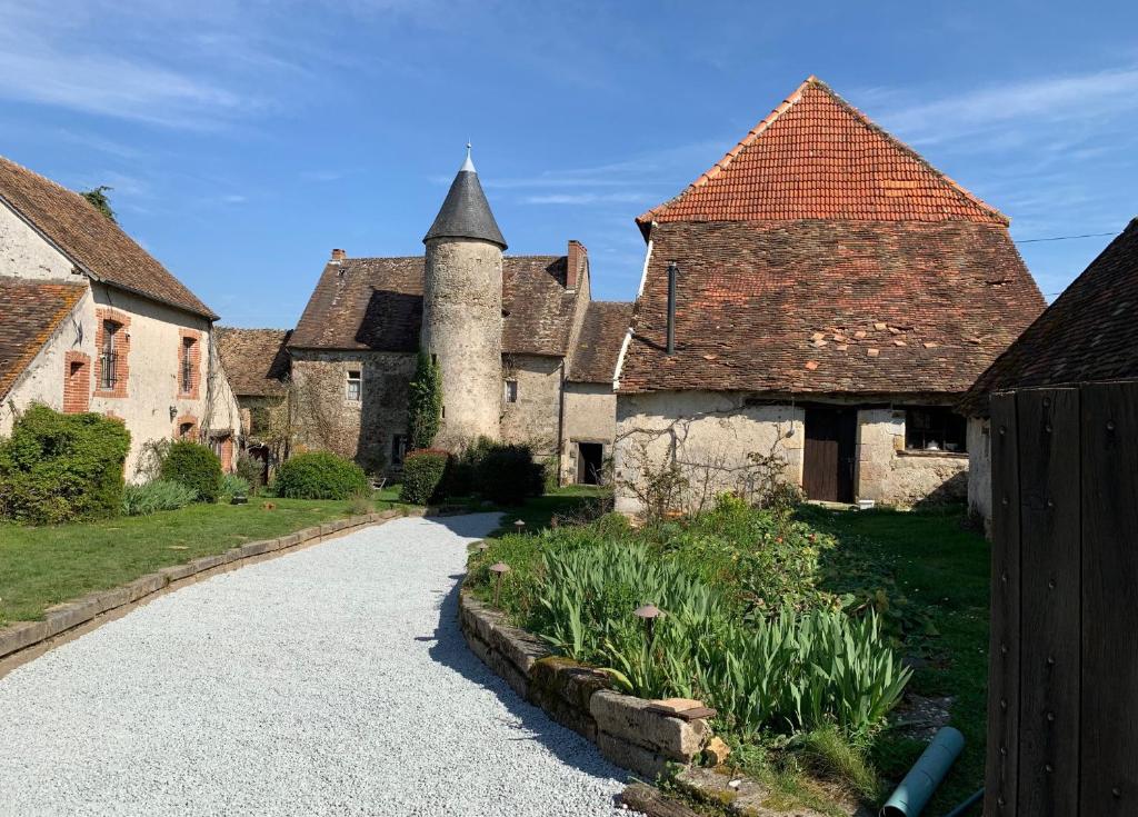 an old building with a turret and a driveway at Chateau Mareuil in Brigueuil-le-Chantre