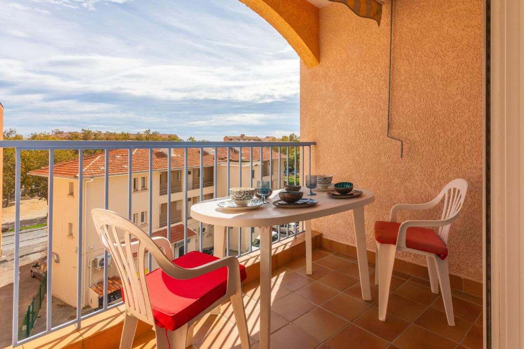 a balcony with a table and chairs and a view at Appartement à deux pas de la mer in Fréjus