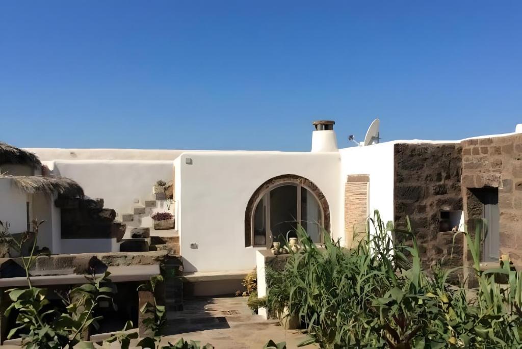 a white house with plants in front of it at Dammuso Civulia Pantelleria in Pantelleria