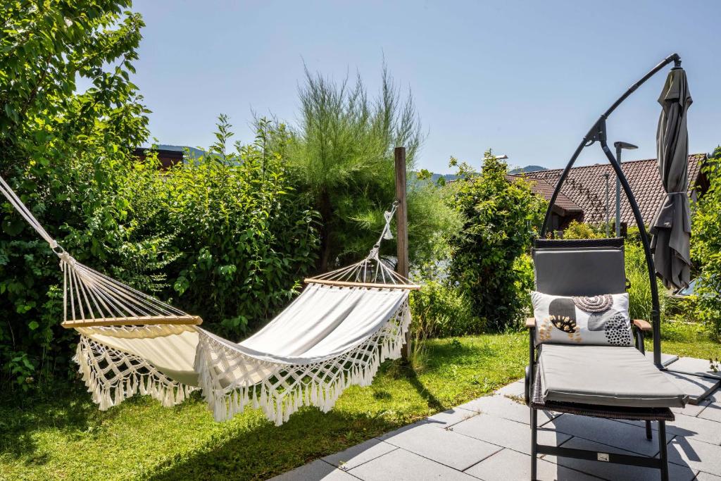 a hammock and a chair in a garden at Haus Albi in Waldkirch