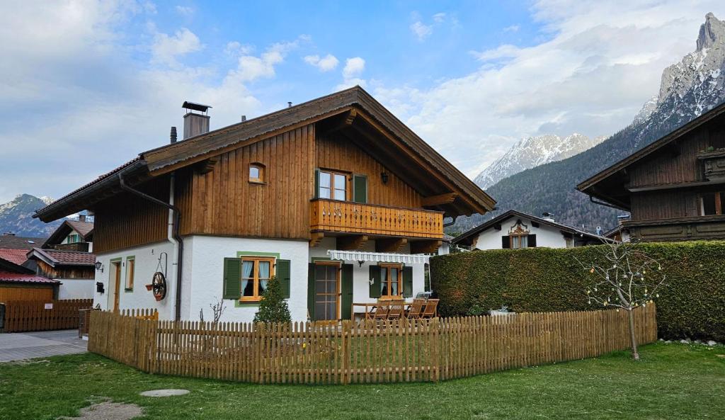 a wooden house with a fence in front of it at Bletschers Hoamat in Mittenwald