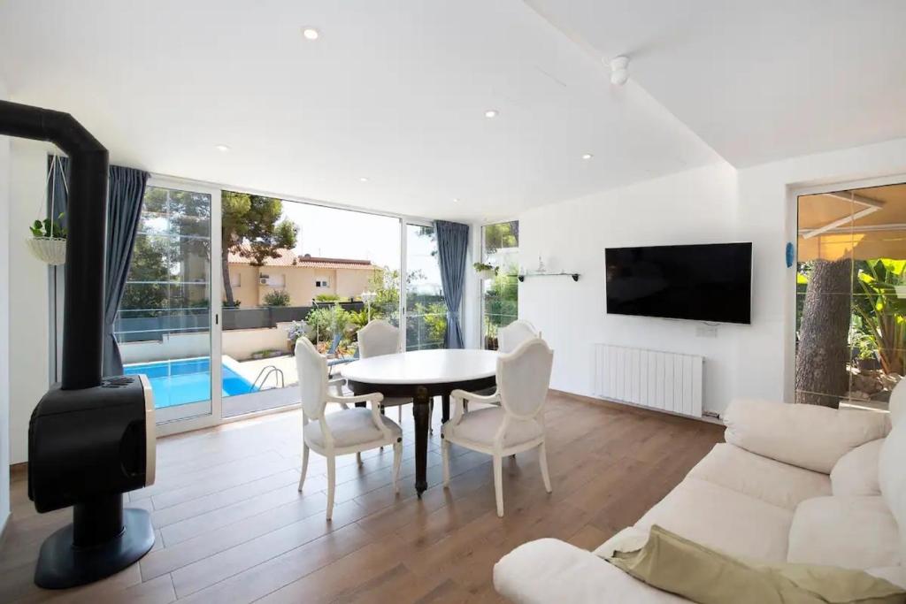 a living room with a white couch and a table at Ethel in Castelldefels