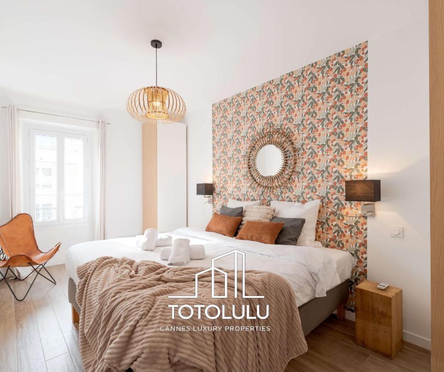 a bedroom with a large bed and a mirror at Totolulu Cannes Luxury Properties in Cannes