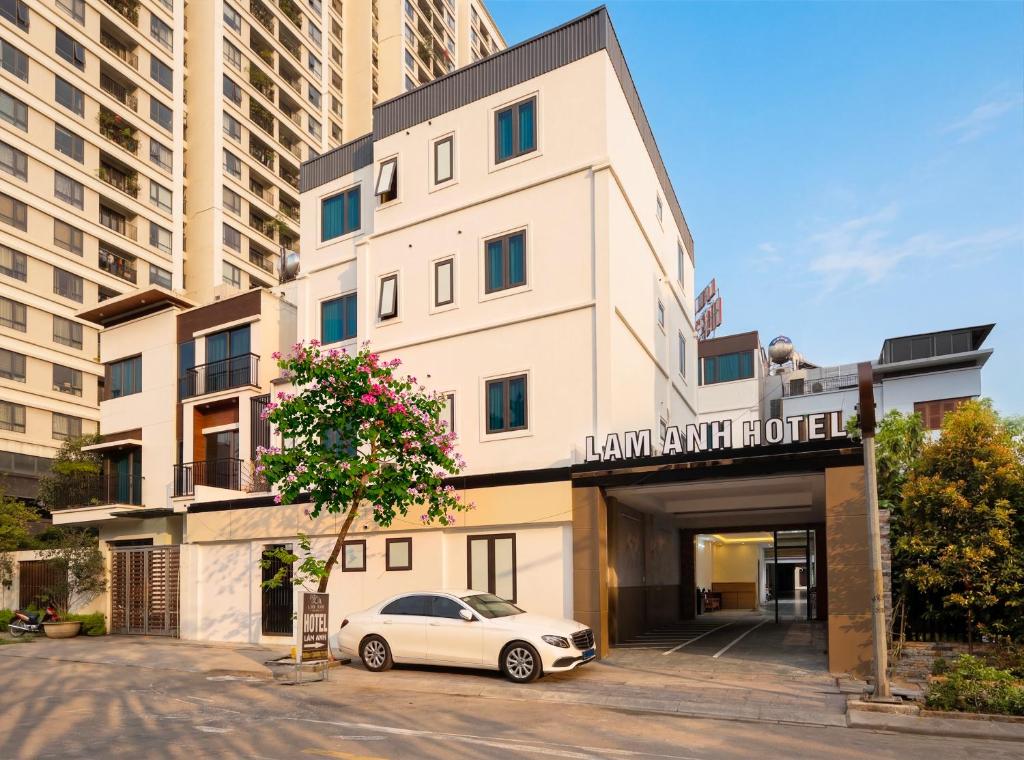a white car parked in front of a building at Lam Anh Hotel 10 Ngoai Giao Doan in Hanoi