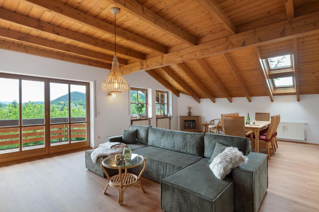 a living room with a couch and a table at Felsenland Idyll in Erfweiler