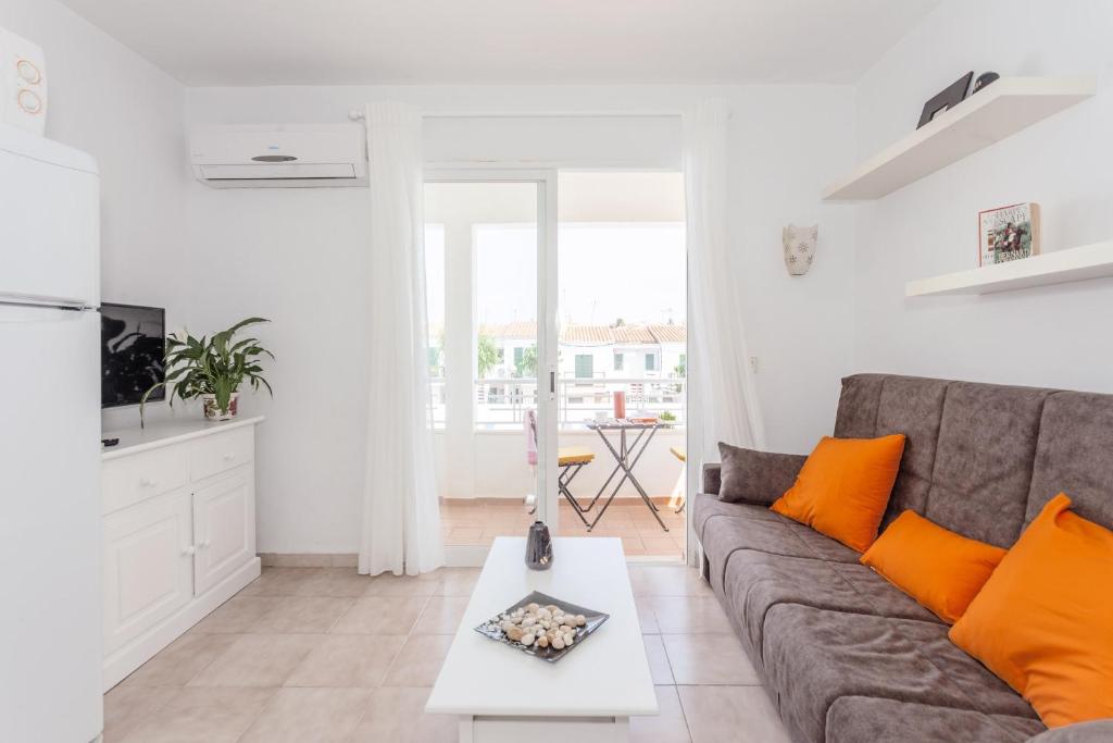 a living room with a couch and a table at Cala'n Blanes Park 228 in Cala en Blanes