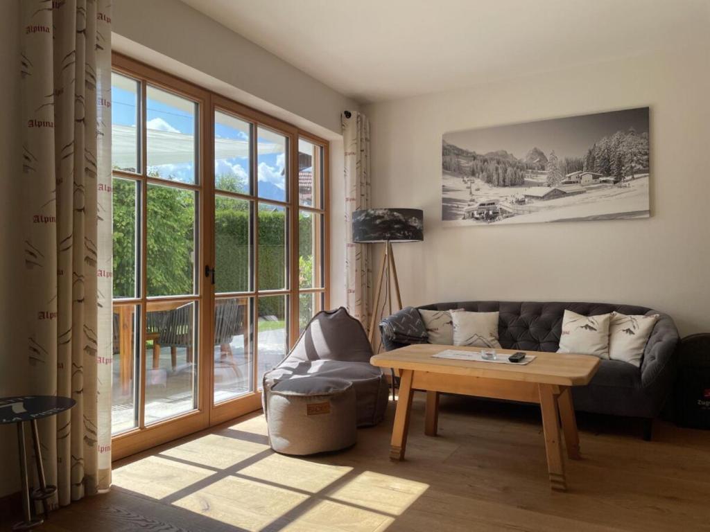 a living room with a couch and a table at Ferienwohnung Max 3 in Garmisch-Partenkirchen