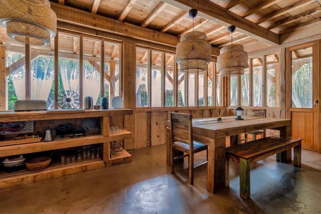 a large room with a table and some windows at Villa Chan-Ly in Lacanau