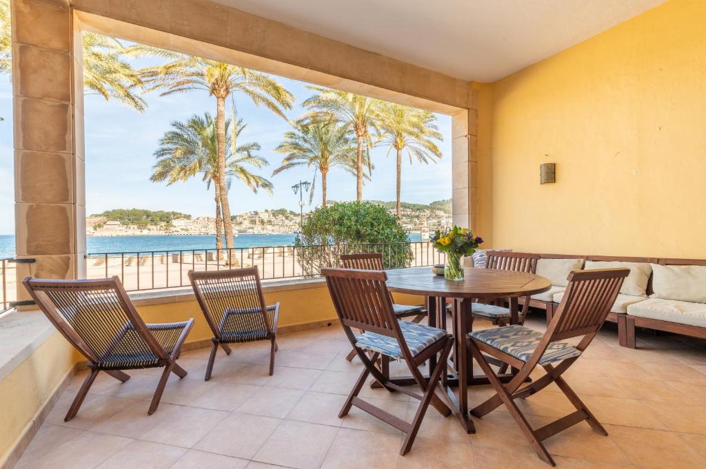 a dining room with a table and chairs and the ocean at Sa Torre in Port de Soller