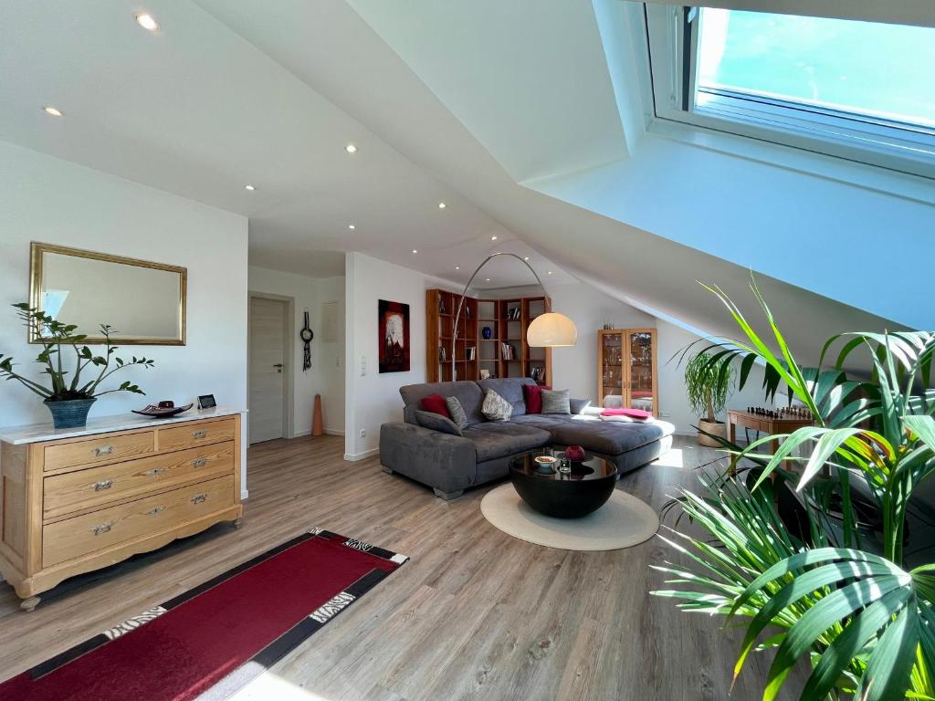 a living room with a couch and a table at Ferienwohnung Klosterblick in Öhningen