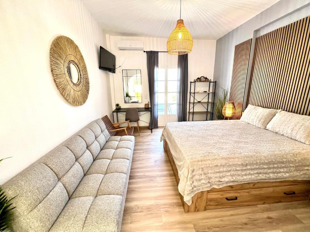a bedroom with a large bed and a couch at aeolian blu 7 in Parikia