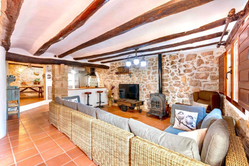 a living room with a couch and a fireplace at La Casuna in Olba