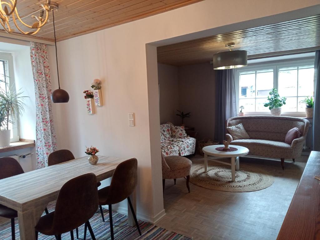 a living room with a table and a couch at Kinderfreundlich Am Dorflädchen in Blankenheim