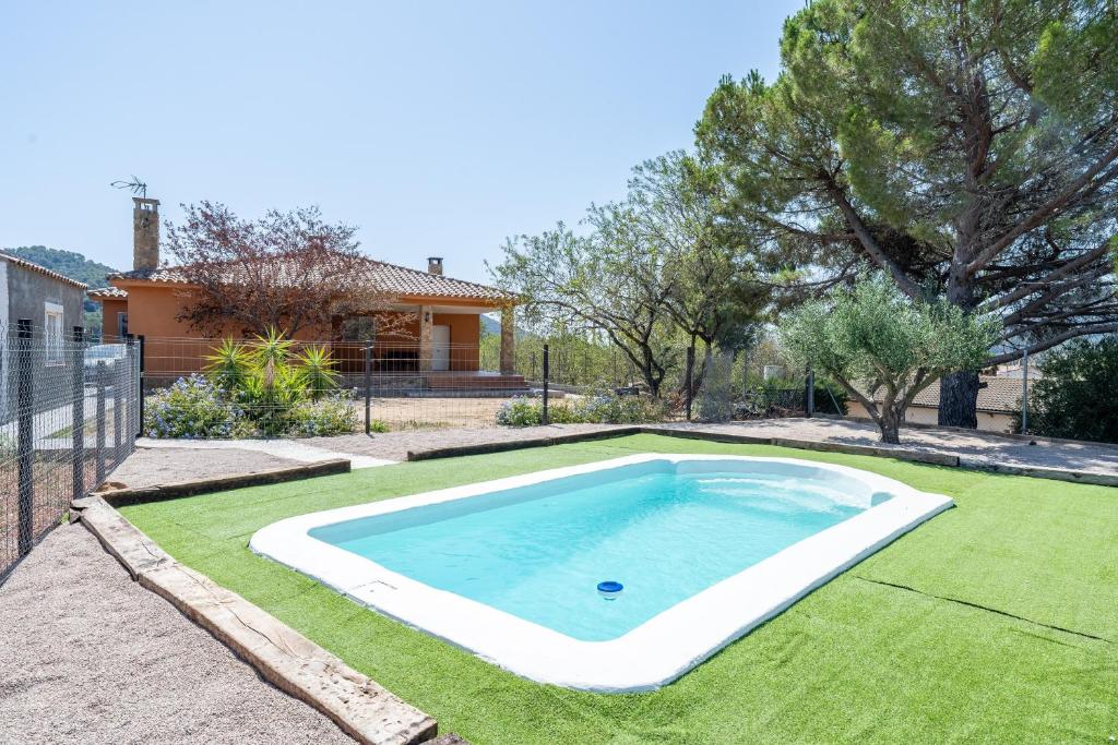 a swimming pool in the yard of a house at Ca La Cuca in Alforja