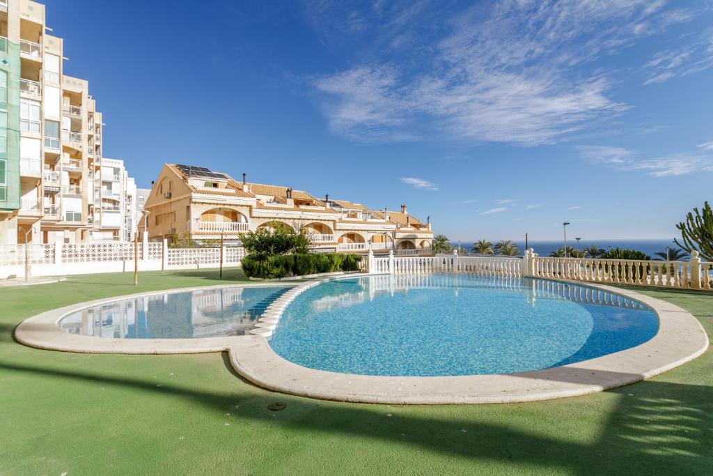 a large swimming pool in front of a building at Los Arenales al Sol in Arenales del Sol