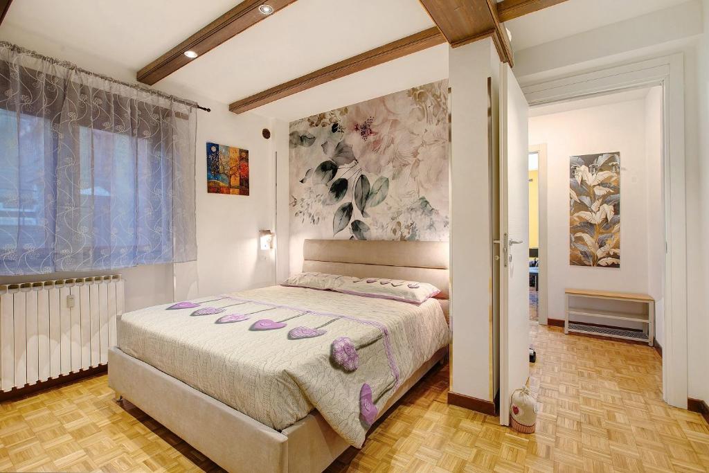 a bedroom with a large bed in a room at Maison de Doi - Chatillon in Châtillon
