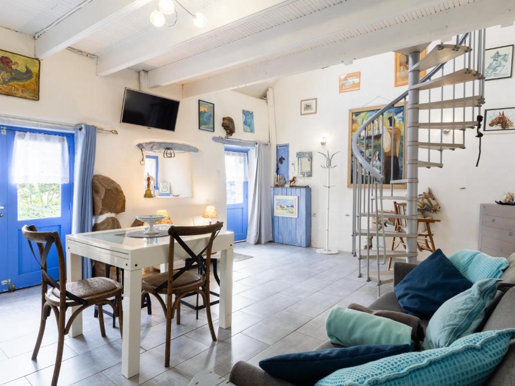 a living room with a table and chairs at Gite Atelier La Croix Blanche in Kermaria-Sulard