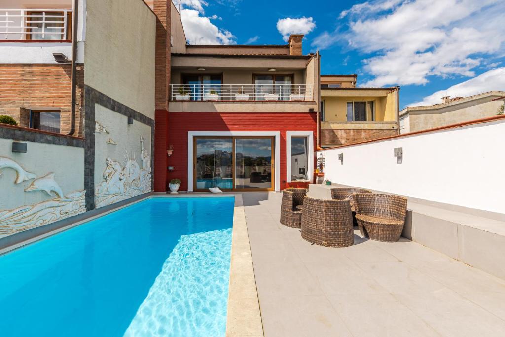 a swimming pool in the backyard of a house at Tranquility Villa with Pool Private Garden & BBQ by PikHost in Tirana