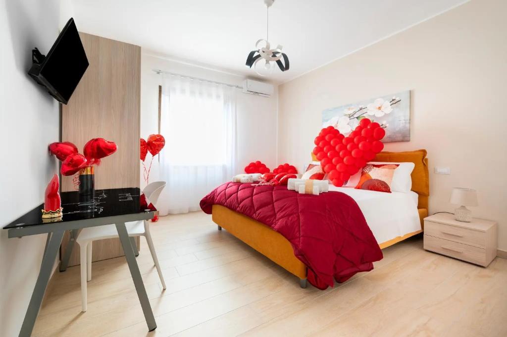 a bedroom with a bed with red balloons on it at Quintessenza – Boutique Rooms in Leverano