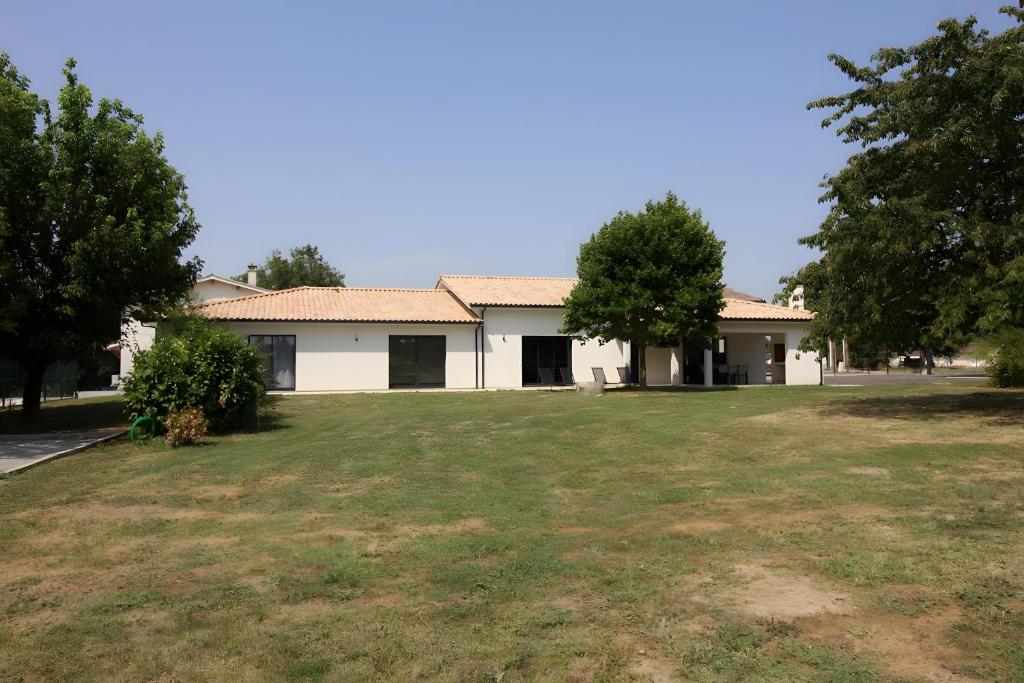 a house with a large yard in front of it at Gîte Basmatho in Yvrac