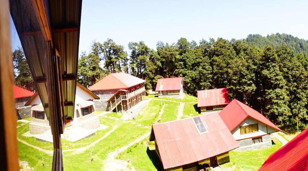 an aerial view of a group of buildings with red roofs at Agyaat Vaas in Bāgi