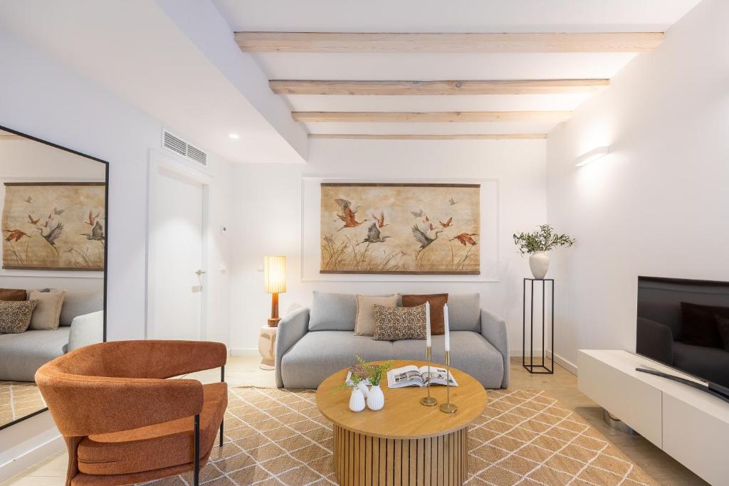 a living room with a couch and a table at Calatrava - Darya Living in Madrid