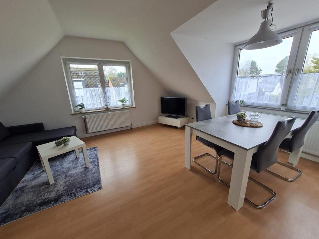 a living room with a table and a couch at Ferienwohnung Küstennest Vitzdorf in Fehmarn