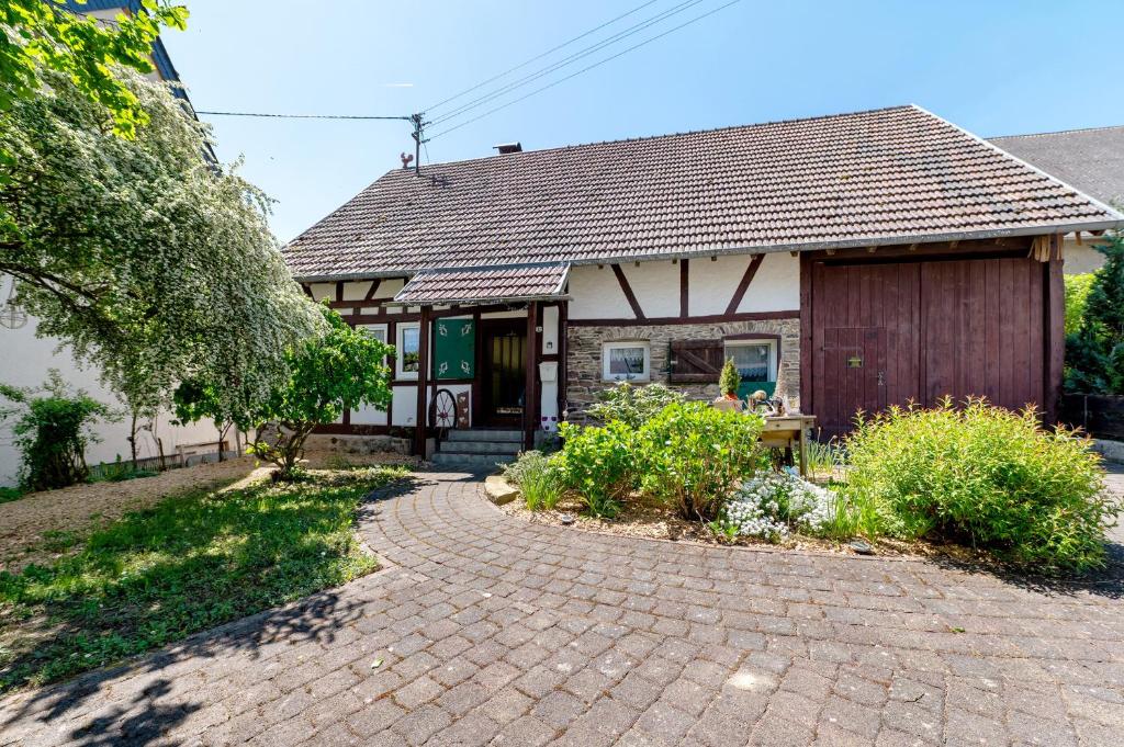 a house with a brick walkway in front of it at Ferienhäuschen Kleine Auszeit in Seesbach