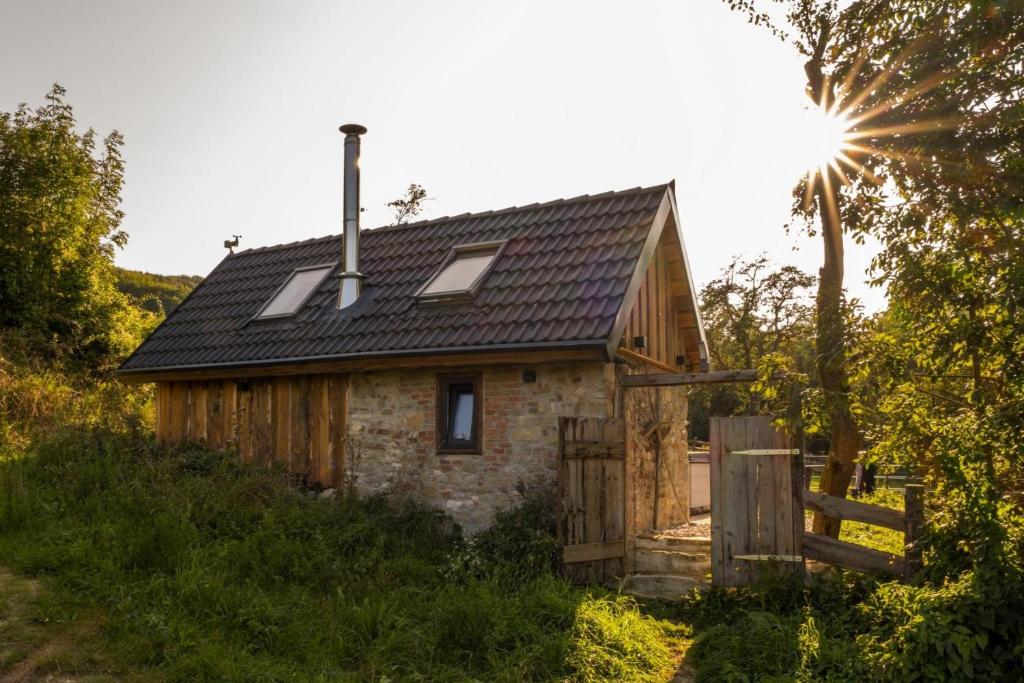 a small stone house with a black roof at Chalet Sternenzauber in Waasen