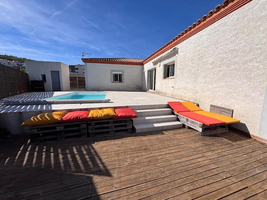 a patio with several pillows sitting on the steps at Villa Lucia in Narbonne