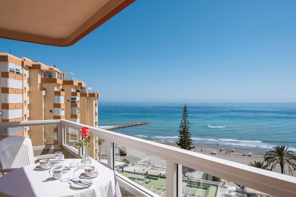 a balcony with a table and a view of the beach at Bloque 76 in Torrox
