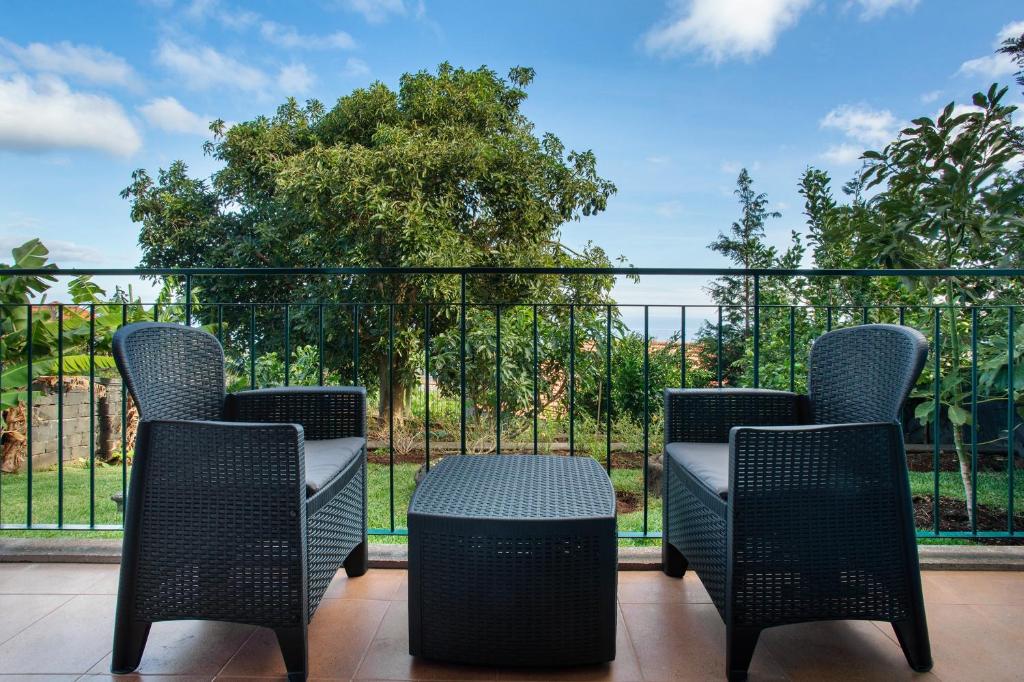 a group of chairs sitting on a balcony with a view at Refugio Dourado in Água de Pena