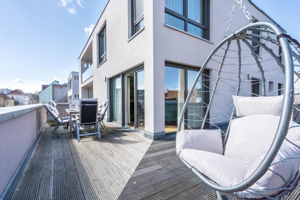 a swing on the balcony of a house at Apartment-Ernst in Finsterwalde