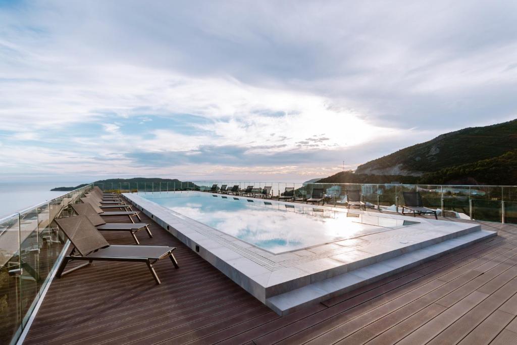 a swimming pool on the roof of a building at Sobre Suites in Bečići