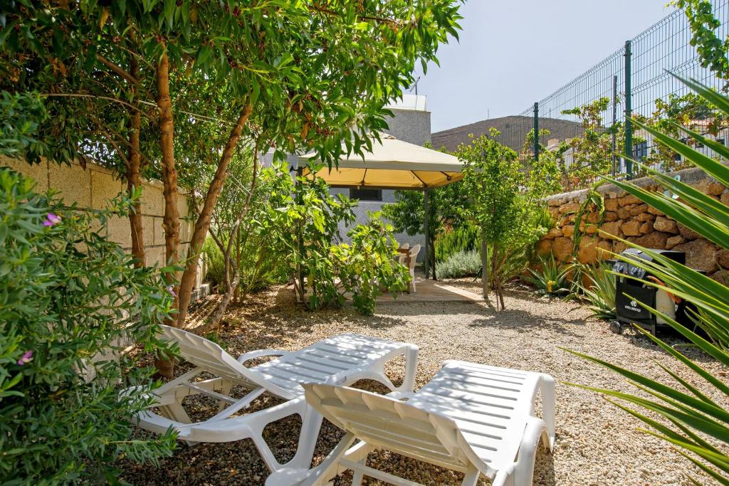 two white chairs and a table and sidx sidx sidx sidx sidx at Chez Martine Tenerife in Granadilla de Abona
