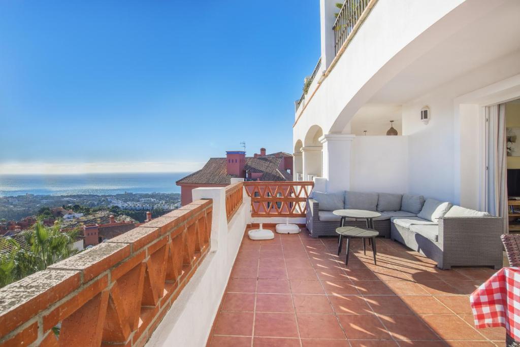 a balcony with a couch and a table at Astonishing view modern apartment in Sitio de Calahonda
