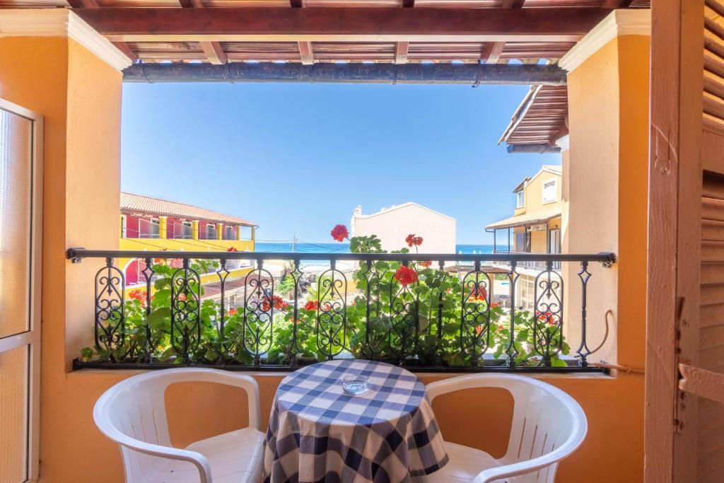 a table and chairs on a balcony with a view of the ocean at Mires House Side First Floor 7 in Agios Gordios