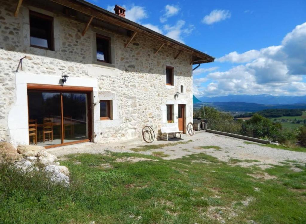 a stone house with a view of the mountains at Les Bellevues in Moye