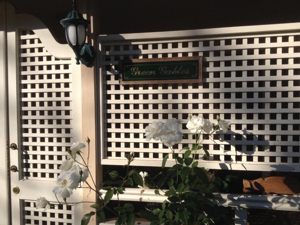 a window with a sign on it with a plant at Green Gables in Brisbane