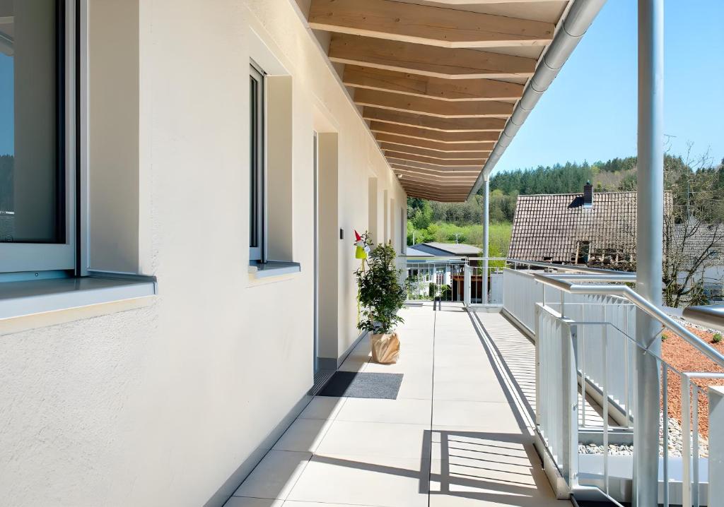a balcony with white walls and a wooden ceiling at Ferienwohnungen Walz in Pfullendorf