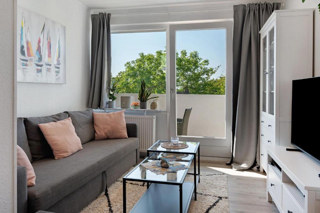 a living room with a couch and a window at Ferienappartement Holm Ostsee in Brasilien