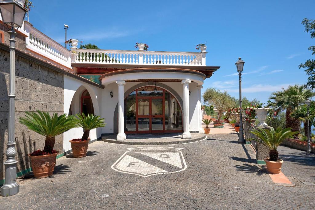 a building with a gate with a sign on it at Villa Azzurra in Massa Lubrense
